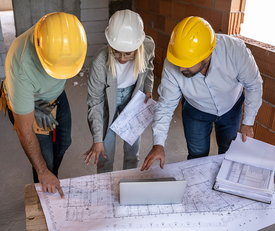 Construction Development Team Reviewing Architect Blueprints