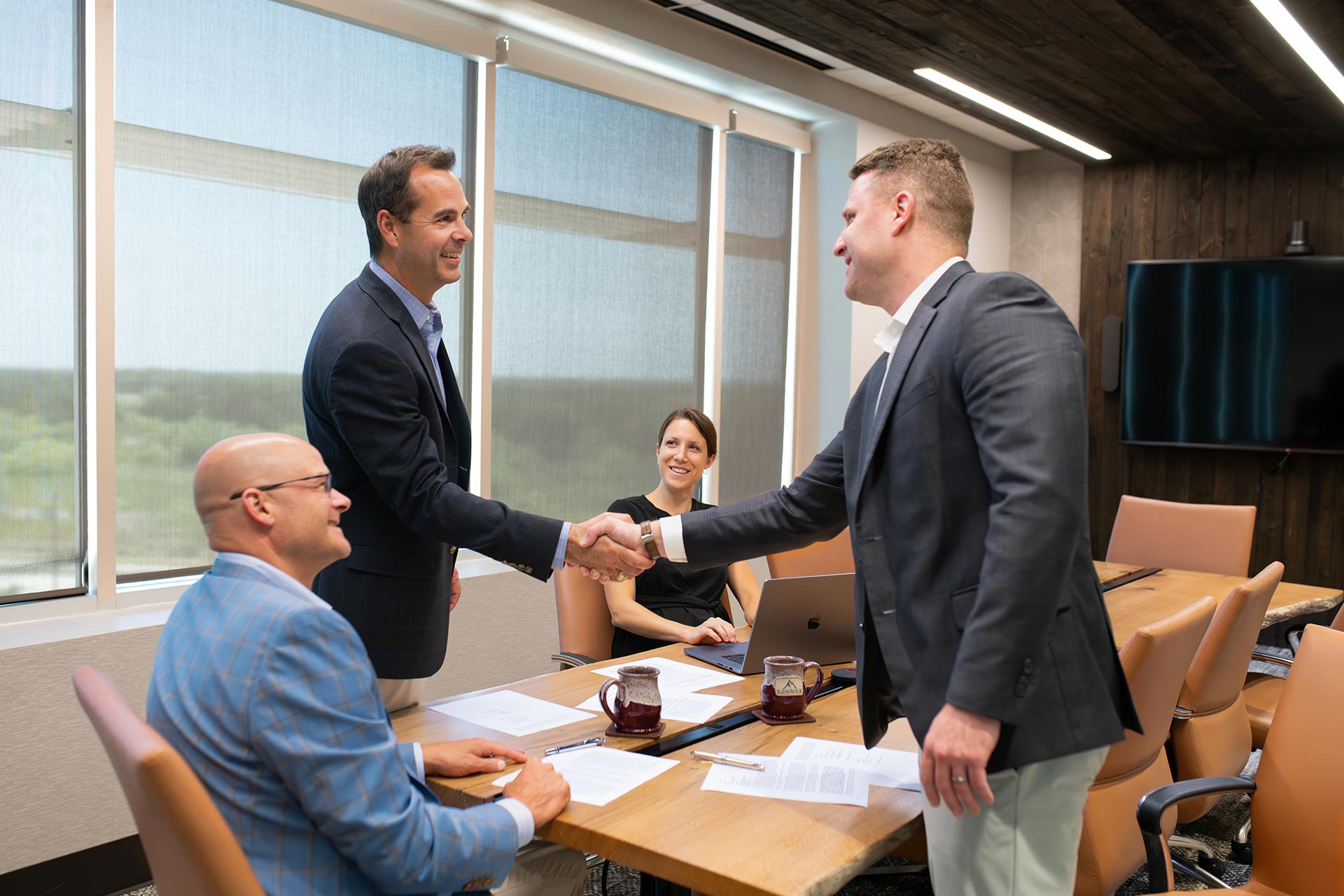 Group in office shaking hands