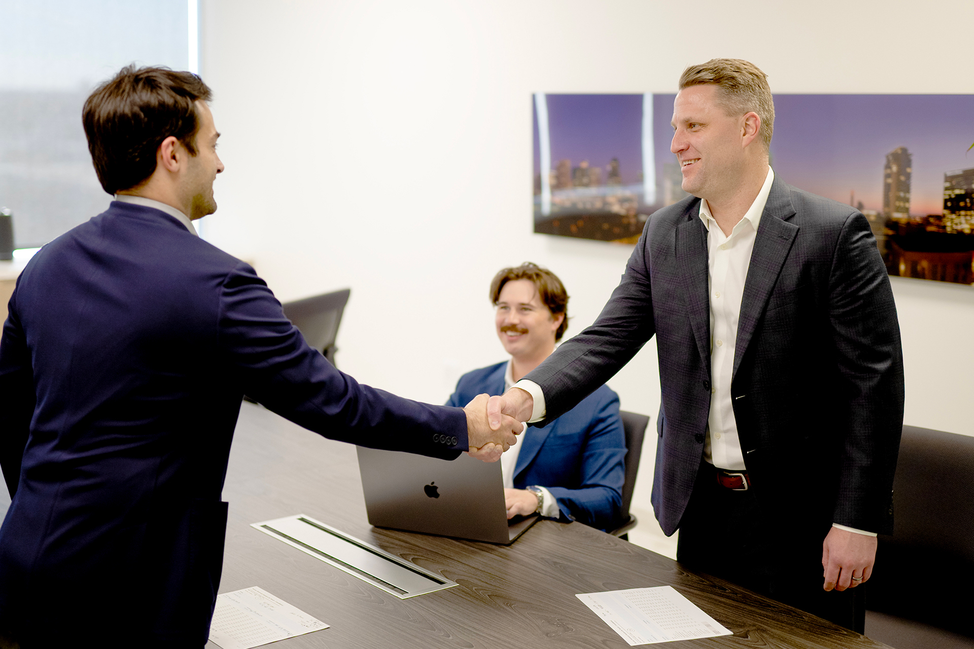 Group in office shaking hands
