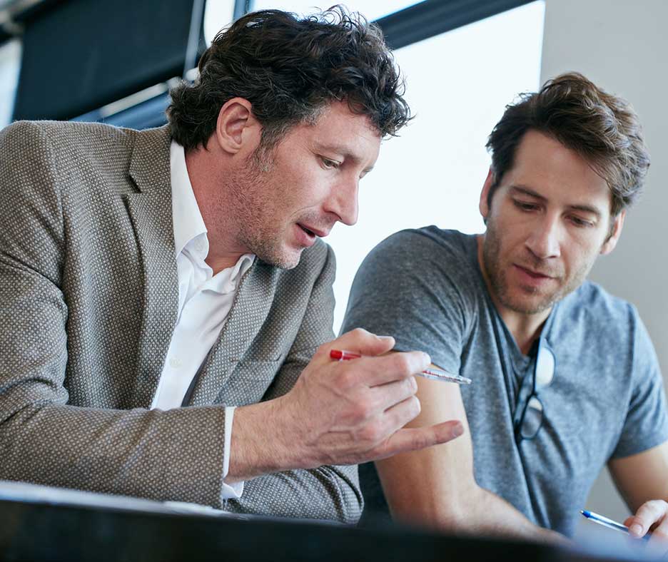 Two businessmen reviewing document